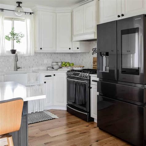 white cabinets with black appliances